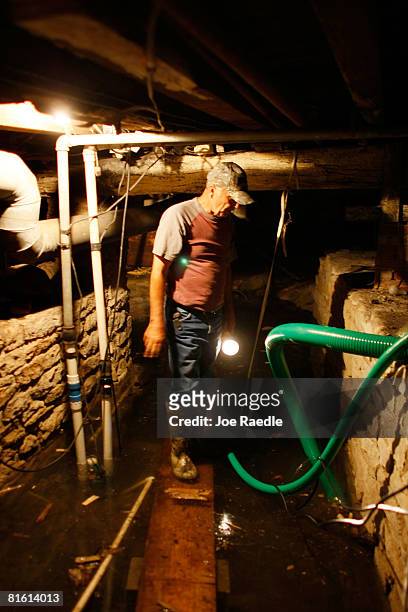 Rex Hipes checks on the sump pump in the basement of the Clarksville Christian church they fight to keep the flooding Mississippi River from...