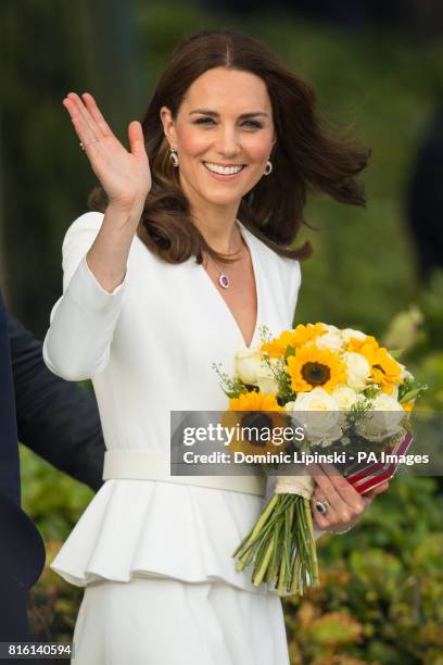 The Duchess of Cambridge waves to the crowd as she leaves the Spire Building, Warsaw, after attending a young entrepreneurs event, on day one of...