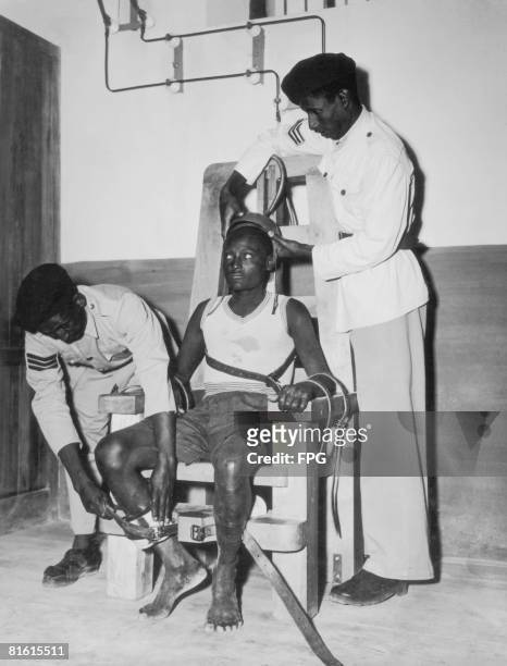 Prisoner is strapped into the electric chair at Addis Ababa prison, circa 1950.