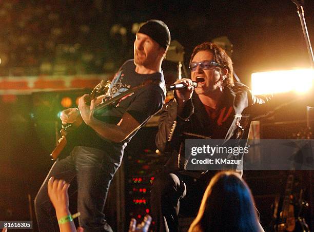 Bono, lead singer of U2, performs during the halftime show at Super Bowl XXXVI in the Superdome, New Orleans, Louisiana, February 3, 2002.