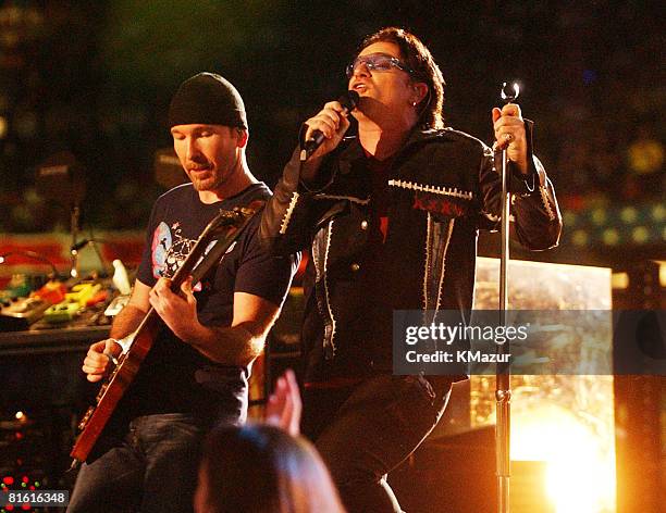 Bono, lead singer of U2, performs during the halftime show at Super Bowl XXXVI in the Superdome, New Orleans, Louisiana, February 3, 2002.