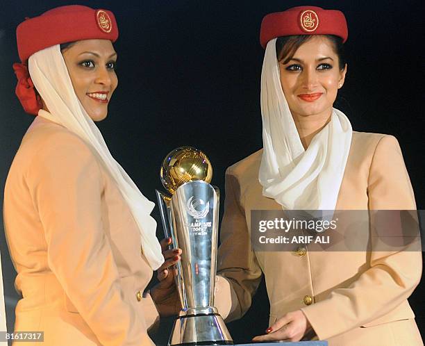 Emirates Airlines cabin crew carry the Cricket Champions Trophy during a launch ceremony in Lahore on June 18, 2008. Pakistan will host the Champions...