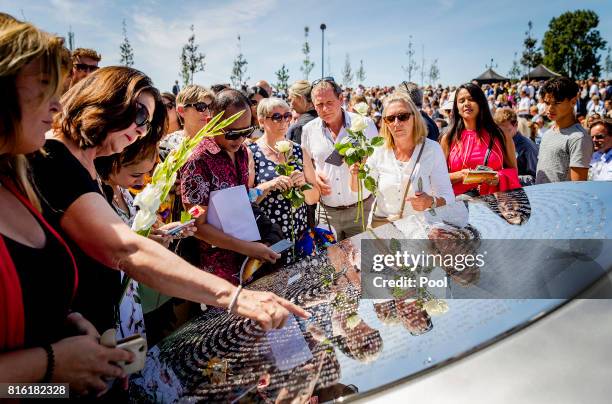 People lay down flowers at the National MH17 monument on July 17, 2017 in Vijfhuizen, Netherlands. The momument is designed by Ronald A. Westerhuis...