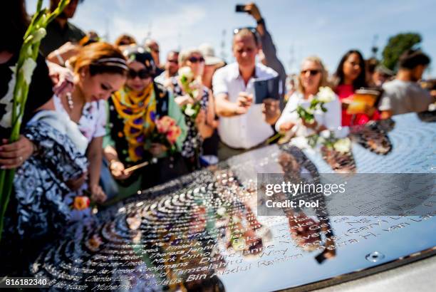 People lay down flowers at the National MH17 monument on July 17, 2017 in Vijfhuizen, Netherlands. The momument is designed by Ronald A. Westerhuis...