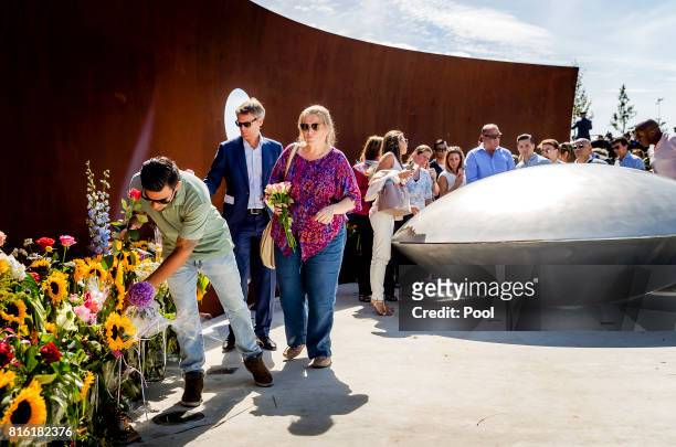 People lay down flowers at the National MH17 monument on July 17, 2017 in Vijfhuizen, Netherlands. The momument is designed by Ronald A. Westerhuis...