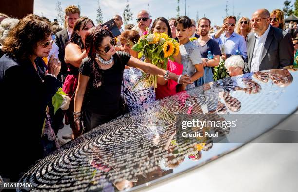 People lay down flowers at the National MH17 monument on July 17, 2017 in Vijfhuizen, Netherlands. The momument is designed by Ronald A. Westerhuis...