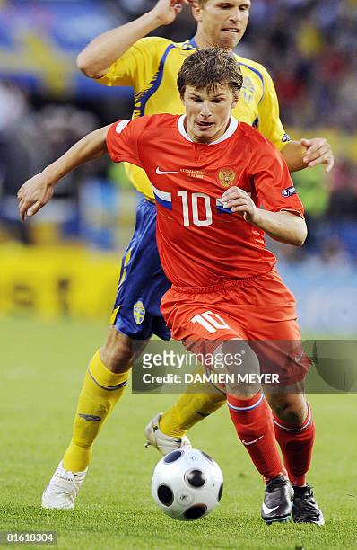 Russian forward Andrei Arshavin fights for the ball in front of Swedish midfielder Anders Svensson during the Euro 2008 Championships Group D...
