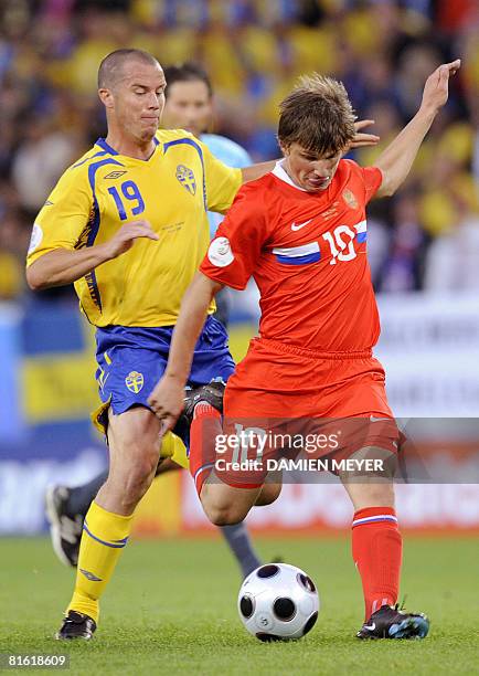 Russian forward Andrei Arshavin and Swedish midfielder Daniel Andersson fight for the ball during the Euro 2008 Championships Group D football match...