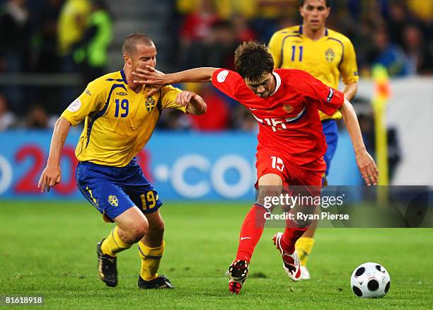 Diniyar Bilyaletdinov of Russia is chased by Daniel Andersson of Sweden during the UEFA EURO 2008 Group D match between Russia and Sweden at Stadion...