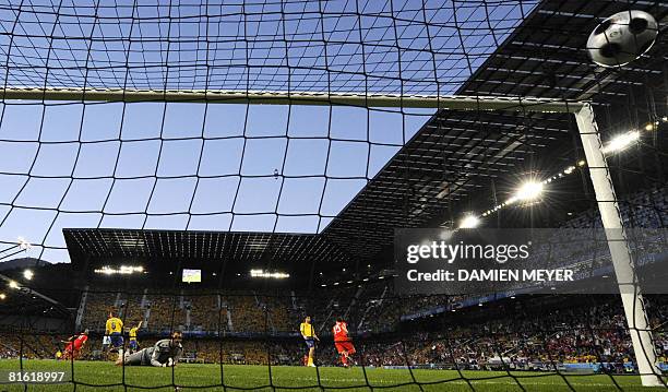 Swedish goalkeeper Andreas Isaksson eyes the ball in the net after the goal of Russian forward Roman Pavlyuchenko during the Euro 2008 Championships...