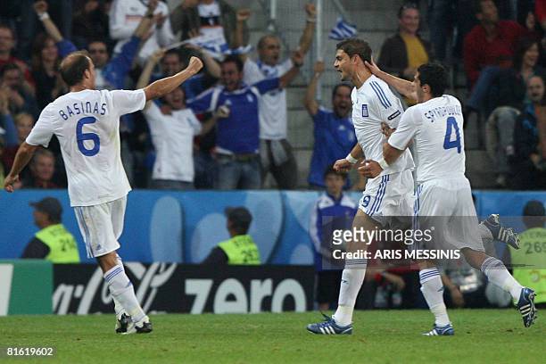 Greek midfielder Angelos Basinas , Greek forward Angelos Charisteas and Greek midfielder Nikos Spiropoulos jubilate after Charisteas scored a goal...