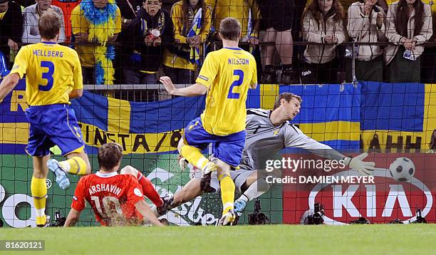 Russian forward Andrei Arshavin scores a goal as Swedish goalkeeper Andreas Isaksson misses the ball during the Euro 2008 Championships Group D...