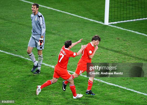 Andrei Arshavin of Russia celebrates with his team mate Konstantin Zyrianov after scoring his teams second goal while goalkeeper Andreas Isaksson of...