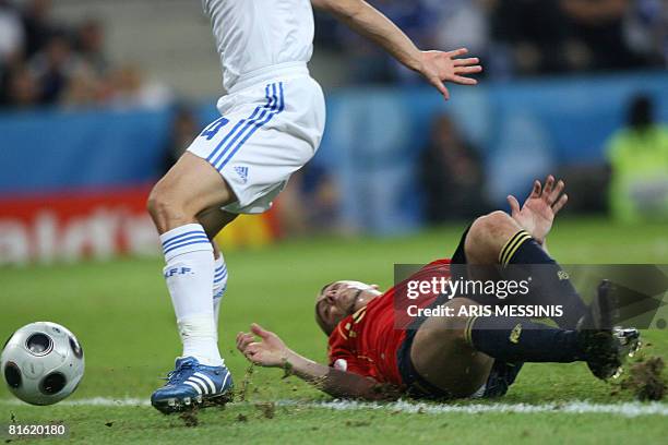 Greek midfielder Nikos Spiropoulos controls the ball as Spanish forward Sergio Garcia lays on the ground during the Euro 2008 Championships Group D...