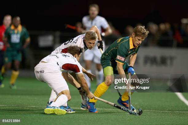 Tim Drummond of South Africa is put under pressure by Jan Philipp Rabente of Germany during the Group B match between South Africa and Belgium on day...