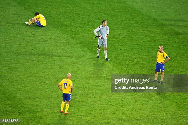 Johan Elmander , Henrik Larsson , goalkeeper Andreas Isaksson and Fredrik Ljungberg of Sweden look dejected after defeat in during the UEFA EURO 2008...