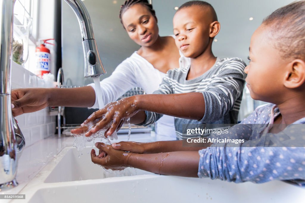 Family washing their hands together.