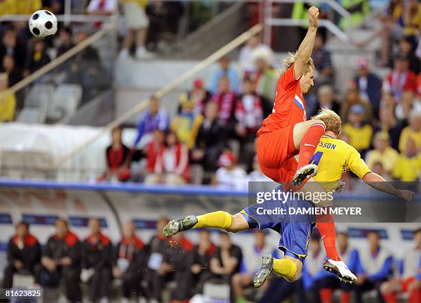 Swedish midfielder Daniel Andersson and Russian defender Sergei Ignashevich jump to head off the ball during the Euro 2008 Championships Group D...