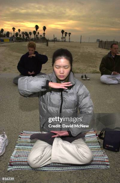 Cindy Lee practices early morning Falun Dafa exercises at Santa Monica State Beach, March 3, 2001 in Santa Monica, CA. Also known as Falun Gong,...