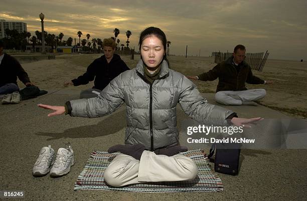 Cindy Lee practices early morning Falun Dafa exercises at Santa Monica State Beach, March 3, 2001 in Santa Monica, CA. Also known as Falun Gong,...