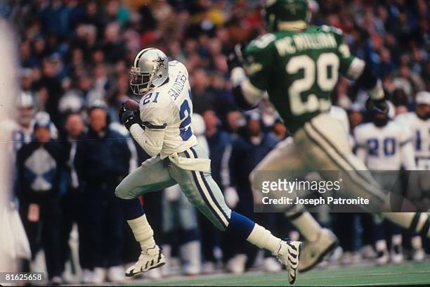 Defensive back Deion Sanders of the Dallas Cowboys returns a punt for a touchdown against the Philadelphia Eagles at Texas Stadium in the 1995 NFC...