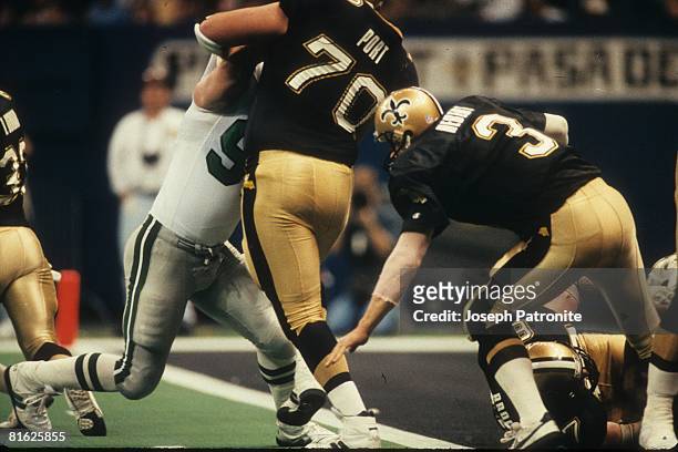 Defensive end Reggie White of the Philadelphia Eagles sacks quarterback Bobby Hebert the New Orleans Saints for a safety in the Superdome in the 1992...