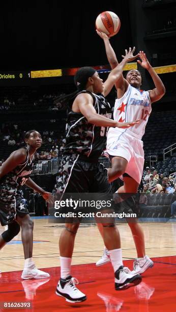 Ivory Latta of the Atlanta Dream shoots against Vickie Johnson of the San Antonio Silver Stars at Philips Arena on June 18, 2008 in Atlanta, Georgia....