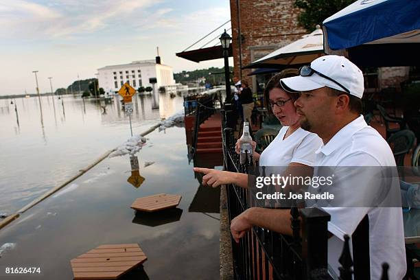 Nathan Murders and his wife April Murders look out at the flooding Mississippi River as they enjoy a drink at The Drake restaurant June 18, 2008 in...