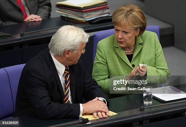 German Chancellor Angela Merkel chats with Vice Chancellor and Foreign Minister Frank-Walter Steinmeier at the Bundestag before she gave a government...