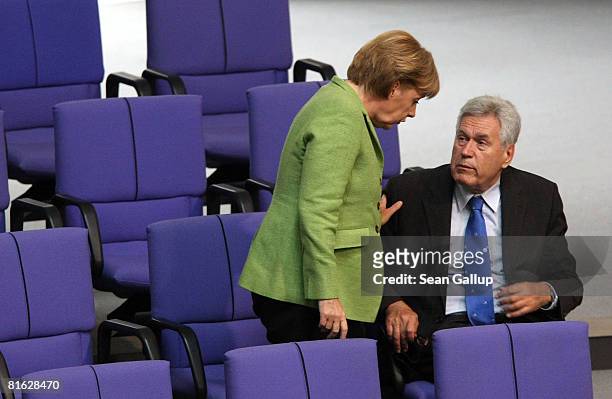German Chancellor Angela Merkel chats with Economy Minister Michael Glos at the Bundestag after she gave a government declaration on the future of...