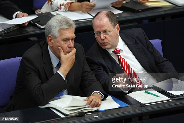 German Finance Minister Peer Steinbrueck chats with Economy Minister Michael Glos at the Bundestag after Chancellor Angela Merkel gave a government...