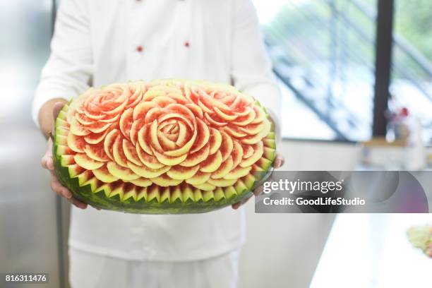 chef holding a carved watermelon - food sculpture stock pictures, royalty-free photos & images