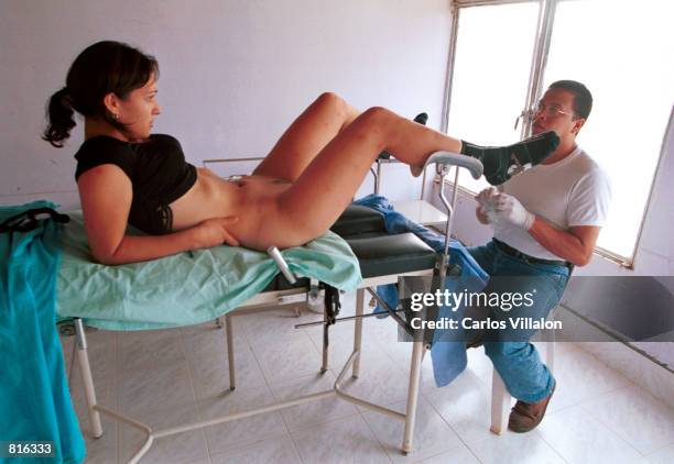 Doctor checks a prostitute for sexually transmitted diseases February 21, 2001 in Peas Coloradas, Colombia. In the Caguan river towns, controlled by...