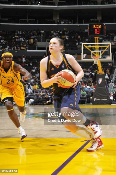 Lindsay Whalen of the Connecticut Sun makes a move to the basket past Marie Ferdinand-Harris of the Los Angeles Sparks during the game at Staples...