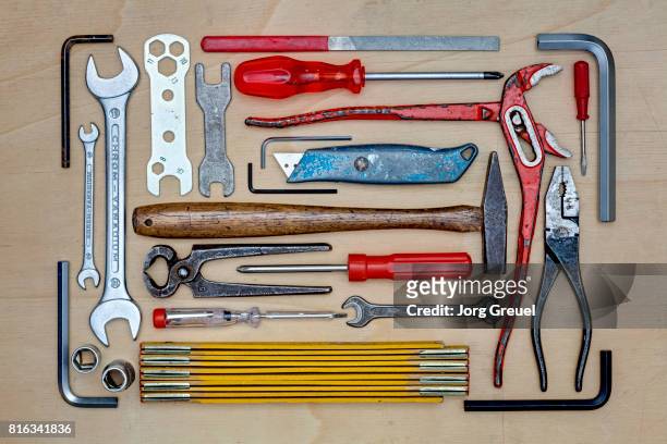 various tools arranged on a wooden table top (top view) - knolling tools stock pictures, royalty-free photos & images