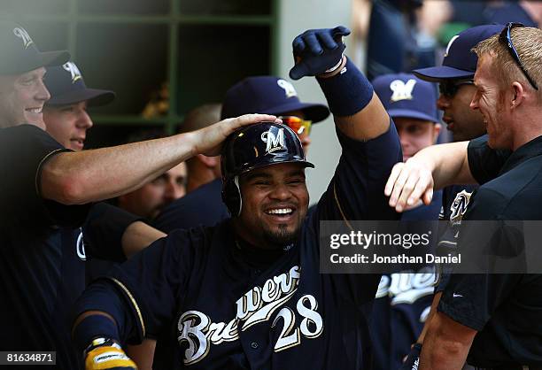 Prince Fielder of the Milwaukee Brewers celebrates with teammates in the dugout after hitting an inside-the-park home run in the 5th inning against...