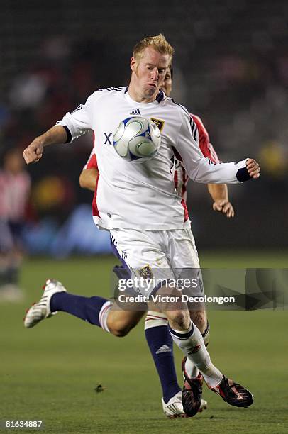 Nat Borchers of Real Salt Lake shields the ball from Ante Razov of CD Chivas USA in the second half during their MLS game at the Home Depot Center on...