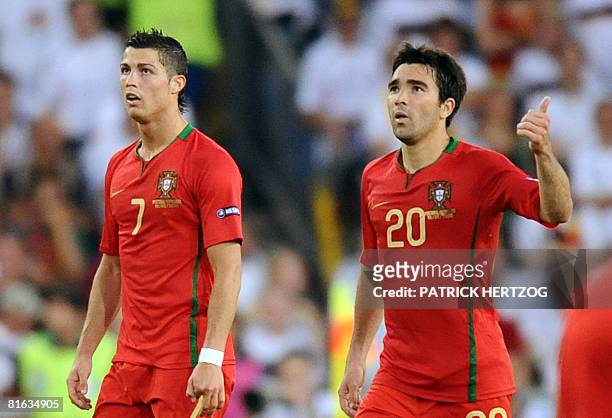 Portuguese midfielder Deco gives a thumbs-up next to forward teammate Cristiano Ronaldo after forward Nuno Gomes scored the team's first goal during...