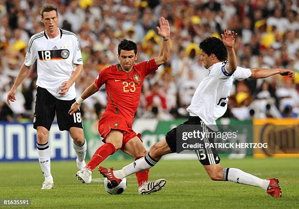 Portuguese forward Helder Postiga is challenged by German midfielders Tim Borowski and Michael Ballack during the Euro 2008 Championships...