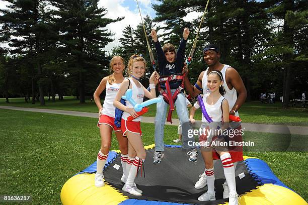 Members of the Detroit Shock dance team, Shockwave, pose with a camper during the 2008 Detroit Shock "WNBA Fit" Picnic at Bloomer State Park on June...