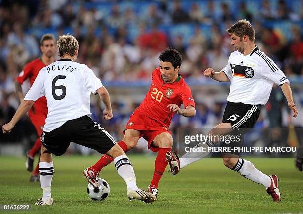 Portuguese midfielder Deco is challenged for the ball by German midfielders Simon Rolfes and Thomas Hitzlsperger during the Euro 2008 Championships...