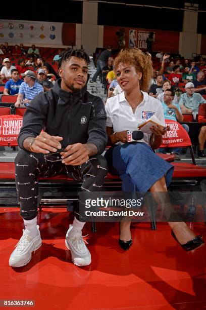 Angelo Russell of the Brooklyn Nets and NBA TV analyst Rosalyn Gold-Onwude watch from the sidelines in a game against the Atlanta Hawks during the...