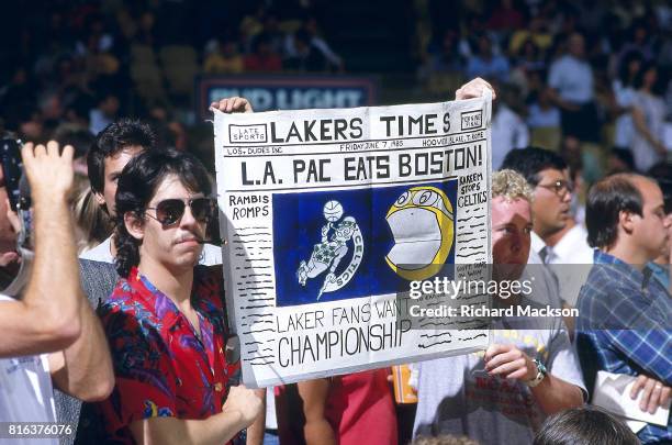 Finals: Los Angeles Lakers fans in stands holding sign that reads L..A. PAC EATS BOSTON LAKER FAN WANTS CHAMPIONSHIP during game vs Boston Celtics at...