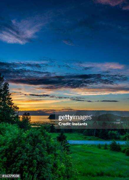 a view of the sun setting on le bic and its national park, in bas saint-laurent (lower saint lawrence) region, québec. - st lawrence river stock pictures, royalty-free photos & images