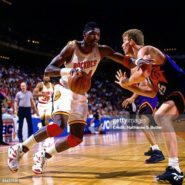 Hakeem Olajuwon of the Houston Rockets drives to the basket against Joe Kleine of the Phoenix Suns in Game Seven of the Western Conference Semifinals...