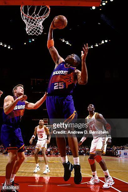 Oliver Miller of the Phoenix Suns grabs a rebound in Game One of the Western Conference Semifinals against the Houston Rockets during the 1994 NBA...