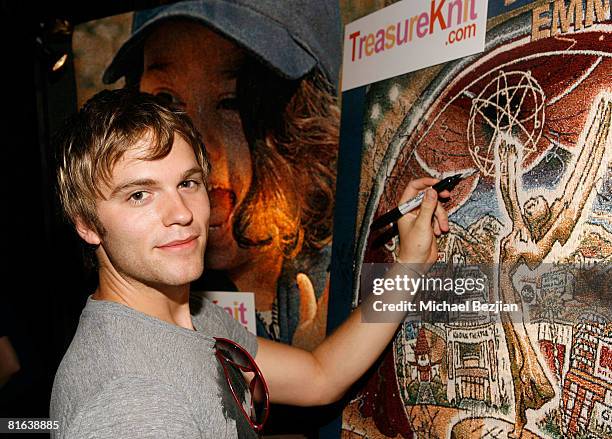 Actor Van Hansis poses with products by Treasureknit.com in the Daytime Emmy official gift lounge produced by On 3 Productions held at the Kodak...