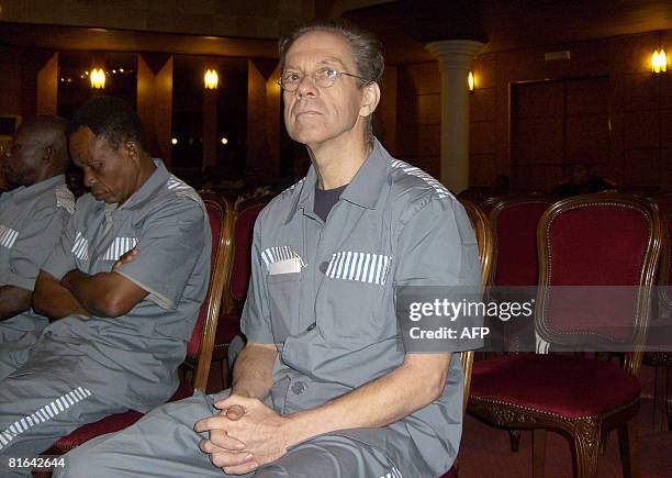 British mercenary Simon Mann sits in a hall turned makeshift courtroom as he listens during his trial in Malabo on June 19, 2008 for plotting to oust...