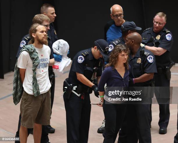 Capitol Police officers arrest health care protester in the atrium area of the Hart Senate Office Building on July 17, 2017 in Washington, DC....