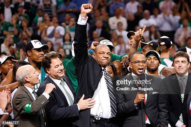 Managing Partners Robert Epstein and Stephen Pagliuca celebrate with head coach Doc Rivers of the Boston Celtics after the Celtics defeated the Los...